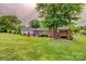 A spacious backyard features well-maintained green grass and a brick home at 800 Sunset Rd, Cherryville, NC 28021