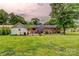 A spacious backyard features well-maintained green grass and a brick home with a patio at 800 Sunset Rd, Cherryville, NC 28021