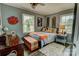 This bedroom features two windows, a baseball-themed ceiling fan, and a unique Clemson paw decoration at 800 Sunset Rd, Cherryville, NC 28021