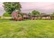 Charming brick home featuring lush landscaping, an American flag, and an inviting covered carport at 800 Sunset Rd, Cherryville, NC 28021