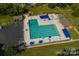 Overhead view of community pool, lounge chairs, umbrellas, and surrounding buildings at 8017 Prince George Rd, Charlotte, NC 28210