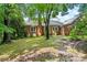 Expansive backyard featuring a classic brick home with a well-maintained lawn at 8017 Prince George Rd, Charlotte, NC 28210