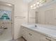 Well-lit bathroom with a single sink vanity, and white cabinets at 8017 Prince George Rd, Charlotte, NC 28210