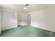 Bedroom with closet featuring clean, neutral-colored walls and green carpet at 8017 Prince George Rd, Charlotte, NC 28210