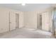 Spacious bedroom featuring neutral walls, carpet floors, and a view to the bathroom at 8017 Prince George Rd, Charlotte, NC 28210