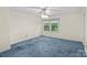 Bedroom featuring blue carpet, bright walls and a double window at 8017 Prince George Rd, Charlotte, NC 28210