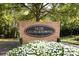 Entrance to the community featuring brick signage surrounded by lush landscaping at 8017 Prince George Rd, Charlotte, NC 28210
