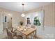 Cozy dining area featuring wainscoting, patterned wallpaper, and a window providing natural light at 8017 Prince George Rd, Charlotte, NC 28210