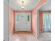Bright foyer with hardwood floors, a white front door, and light peach-painted walls at 8017 Prince George Rd, Charlotte, NC 28210