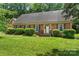Inviting brick home featuring well-maintained landscaping and a welcoming front entrance at 8017 Prince George Rd, Charlotte, NC 28210