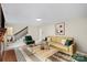Inviting living room with a fireplace, comfortable seating, and stairs leading to the upper level at 8017 Prince George Rd, Charlotte, NC 28210