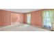 Spacious living area with peach walls, neutral carpeting, and lots of natural light at 8017 Prince George Rd, Charlotte, NC 28210