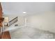 Large living room with a fireplace and stairs at 8017 Prince George Rd, Charlotte, NC 28210