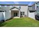 A fenced backyard featuring a well-maintained lawn and covered patio with sliding glass doors at 8018 Saluda Dr, Charlotte, NC 28269