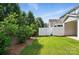 Well-kept lawn adjacent to a white fence line and mature trees at 8018 Saluda Dr, Charlotte, NC 28269