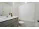 Bathroom with a large mirror, gray vanity, toilet, and white shower curtain at 8018 Saluda Dr, Charlotte, NC 28269