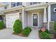 Inviting front entrance features stone accents, fresh landscaping, and a secure CPI security system at 8018 Saluda Dr, Charlotte, NC 28269