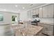 Granite countertop kitchen island featuring a stainless steel sink and modern gray cabinets at 8018 Saluda Dr, Charlotte, NC 28269