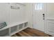 Bright mud room features a bench with storage cubbies and a convenient coat rack at 8018 Saluda Dr, Charlotte, NC 28269