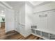 Bright mud room features a bench with storage cubbies and coat hooks near the front door at 8018 Saluda Dr, Charlotte, NC 28269