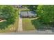 Aerial view of a single-story home featuring a long driveway and green lawn at 8206 Idlewild Rd # 22, Indian Trail, NC 28079