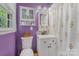Bright bathroom featuring a vanity, a matching cabinet, and a shower with a floral curtain at 8206 Idlewild Rd # 22, Indian Trail, NC 28079