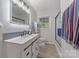 Bright bathroom with a well-lit vanity, modern fixtures, and a glass-enclosed shower area at 8206 Idlewild Rd # 22, Indian Trail, NC 28079