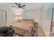 Cozy bedroom featuring a ceiling fan, neutral walls, and a large window offering natural light at 8206 Idlewild Rd # 22, Indian Trail, NC 28079
