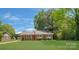 Charming single-story home featuring a well-maintained lawn and beautiful landscaping at 8206 Idlewild Rd # 22, Indian Trail, NC 28079