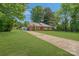 Quaint single-story home with a long driveway and a lush green lawn at 8206 Idlewild Rd # 22, Indian Trail, NC 28079
