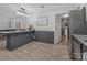 Open kitchen with granite countertops, island and updated cabinetry in gray and white at 8206 Idlewild Rd # 22, Indian Trail, NC 28079