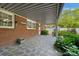 Covered patio with a paved area, brick exterior, and partial view of the well-maintained yard at 8206 Idlewild Rd # 22, Indian Trail, NC 28079