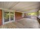 Covered back porch featuring a wood deck and brick siding at 830 Cabaniss Dr, Shelby, NC 28150