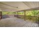 Covered back porch with wood flooring, ceiling, and rail at 830 Cabaniss Dr, Shelby, NC 28150