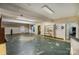 Spacious basement featuring a brick fireplace and a mix of flooring types at 830 Cabaniss Dr, Shelby, NC 28150