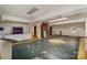 Large basement area with a brick fireplace and concrete flooring at 830 Cabaniss Dr, Shelby, NC 28150