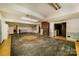 Spacious basement featuring brick fireplace and open layout on concrete flooring at 830 Cabaniss Dr, Shelby, NC 28150