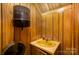 Compact bathroom highlighting retro-style yellow sink and wood-paneled walls at 830 Cabaniss Dr, Shelby, NC 28150