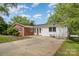 View of the home exterior, highlighting the brick and siding, windows, and the surrounding landscape at 830 Cabaniss Dr, Shelby, NC 28150