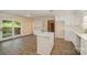 Open concept kitchen with a breakfast island and access to the porch area through sliding glass doors at 830 Cabaniss Dr, Shelby, NC 28150
