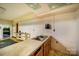 A kitchen featuring a double sink, block walls, and worn countertops, awaiting renovation at 830 Cabaniss Dr, Shelby, NC 28150