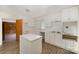 Bright kitchen featuring crisp white cabinets, countertops, updated appliances, and hardwood floors at 830 Cabaniss Dr, Shelby, NC 28150