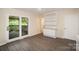 Bright living room with built-in shelving, hardwood floors, and sliding glass doors to the deck at 830 Cabaniss Dr, Shelby, NC 28150