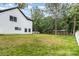 Backyard with green grass, trees, and a white fence surrounding the property at 9527 Walkers Ferry Rd, Charlotte, NC 28214