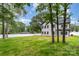 Large backyard with green grass, mature trees, and a white fence surrounding the property at 9527 Walkers Ferry Rd, Charlotte, NC 28214