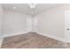 Spacious bedroom with hardwood floors, recessed lighting, and double closet doors at 9527 Walkers Ferry Rd, Charlotte, NC 28214