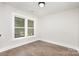Bedroom with hardwood flooring, white walls and baseboards, and double hung windows at 9527 Walkers Ferry Rd, Charlotte, NC 28214