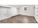Walk-in closet with built in shelving and hardwood floors at 9527 Walkers Ferry Rd, Charlotte, NC 28214