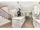 Open-concept kitchen featuring a large island, hardwood floors, and seamless flow to the living spaces at 9527 Walkers Ferry Rd, Charlotte, NC 28214