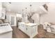 Bright, modern kitchen with large island, white cabinetry, and stainless steel appliances at 9527 Walkers Ferry Rd, Charlotte, NC 28214
